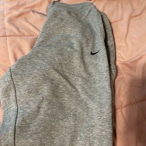 grey nike sweat pants with nike written down the sides